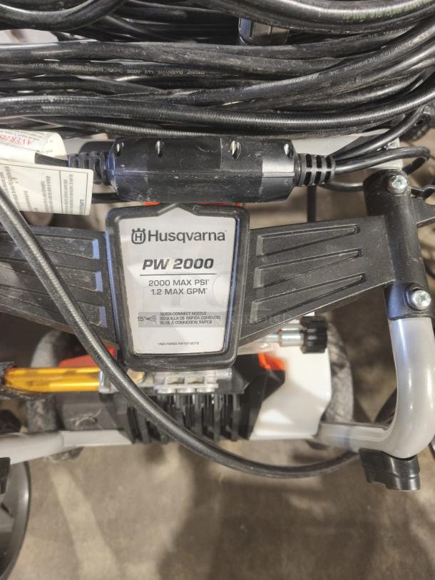 Husqvarna PW2300 Electric Pressure Washer, tested, working; model PW2300; features max 2000 PSI and quick-connect nozzle.