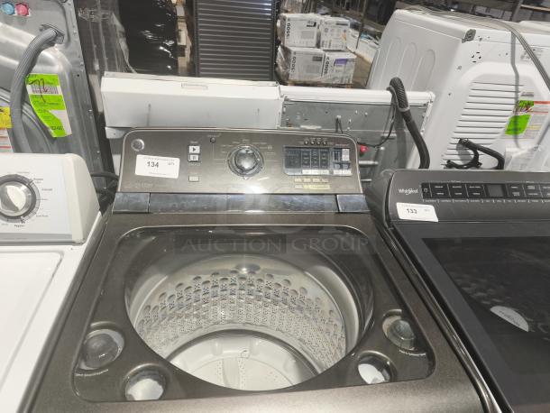 GE 5.0 cu ft top-load washer, model GTWS8655D0MC, featuring steam and SmartDispense, in good condition.