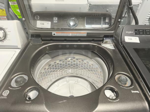 GE 5.0 cu ft top-load washer, model GTWS8655D0MC, with steam, SmartDispense, and control panel visible.