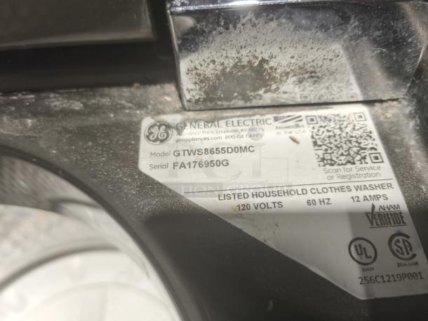 GE 5.0 cu ft Top-Load Washer, Model GTWS8655D0MC, with Steam & SmartDispense. Visible wear, label indicates voltage and serial number.