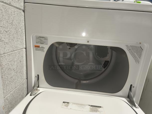 Whirlpool top-load electric dryer, model LE7680XSW2, white, open lid, interior visible, warning labels present.