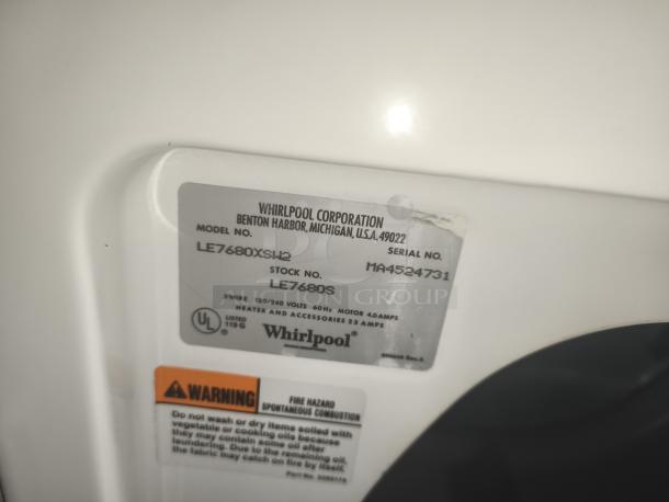 Whirlpool top-load electric dryer, model LE7680XSW2, with visible model and serial number tags, in good condition.