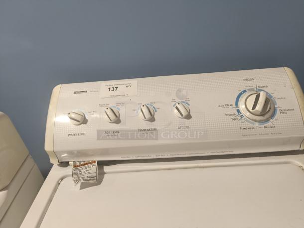 Kenmore top-load washing machine, model 11027721600. Control panel with water level, soil level, and cycle options visible.