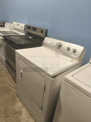 Maytag MGDC400VW0 dryer, white, visible surface wear, mechanical dial, Centennial series, on concrete floor.