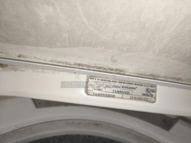 Estate direct-drive top-load washer, model TAWB600DQ0. Visible label shows voltage and serial number details.