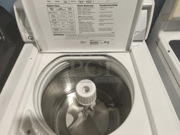 Speed Queen / Alliance AWN412SP111TW01 top-load commercial washer, open lid view, visible care instructions on lid.