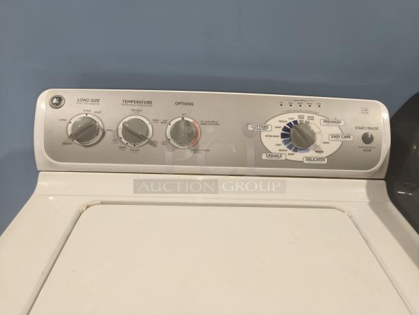 GE 4.1 cu ft top-load washer, model WHRE5550K2WW. Control panel with load size, temperature, and cycle options visible.