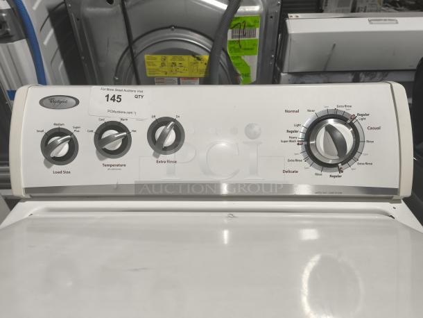 Whirlpool 3.5 cu ft top-load washer, model WTW5200VQ0, features load size, temperature, and cycle controls. Auction tag visible.