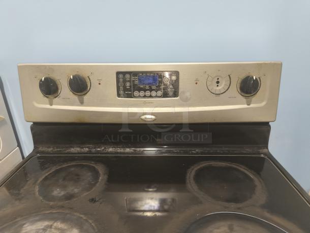 Whirlpool 30" electric ceramic glass range, model RF362LXSS, showing control panel and cooking surface, some wear visible.