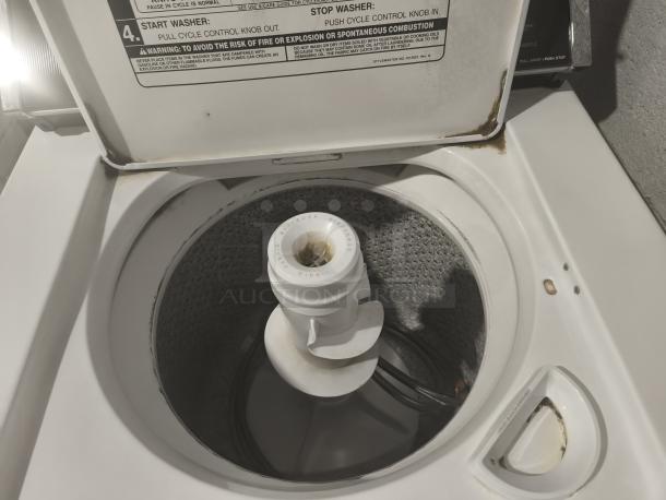 Whirlpool Top-Load Heavy Duty Washer, Model LA5580XTW1. Visible wear on lid edges. Instruction label present inside lid.