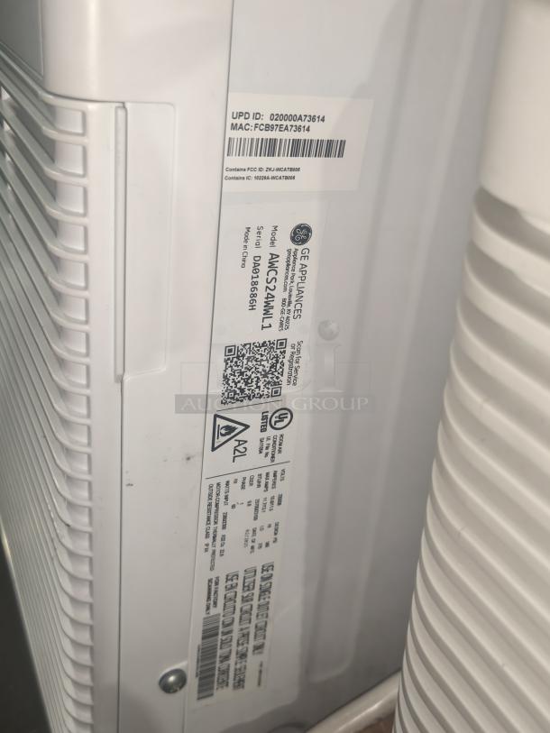 BRAND NEW GE 24,000 BTU Smart Window AC, Model AWCS24WWL, scratch and dent. Labels show model and FCC details.