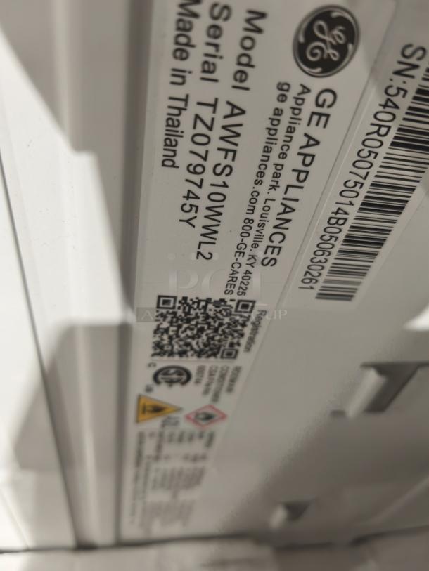 BRAND NEW GE 10,000 BTU Smart Window AC, Model AWFS10WWL, made in Thailand. Tags show serial TZ079745Y.