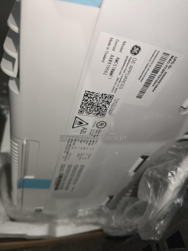 BRAND NEW GE Window Air Conditioner, model AWFS14WWL, 14,000 BTU, minor scratches, white. Tags with product info visible.