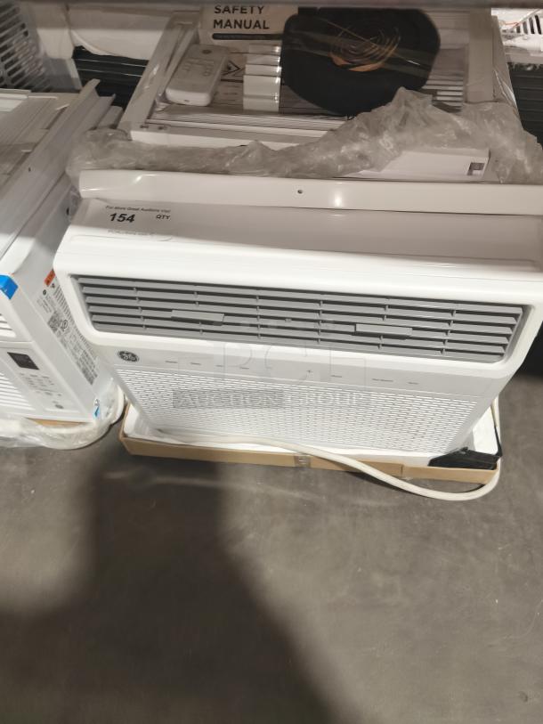 BRAND NEW GE Smart Electronic Window Air Conditioner 14,000 BTU, model AWFS14WWL1, scratch and dent condition, with control panel and safety manual visible.