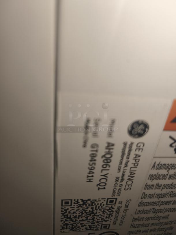 Label close-up of GE Zoneline 6,000 BTU air conditioner, model AHQ06LYCQ1, showing product and serial numbers.