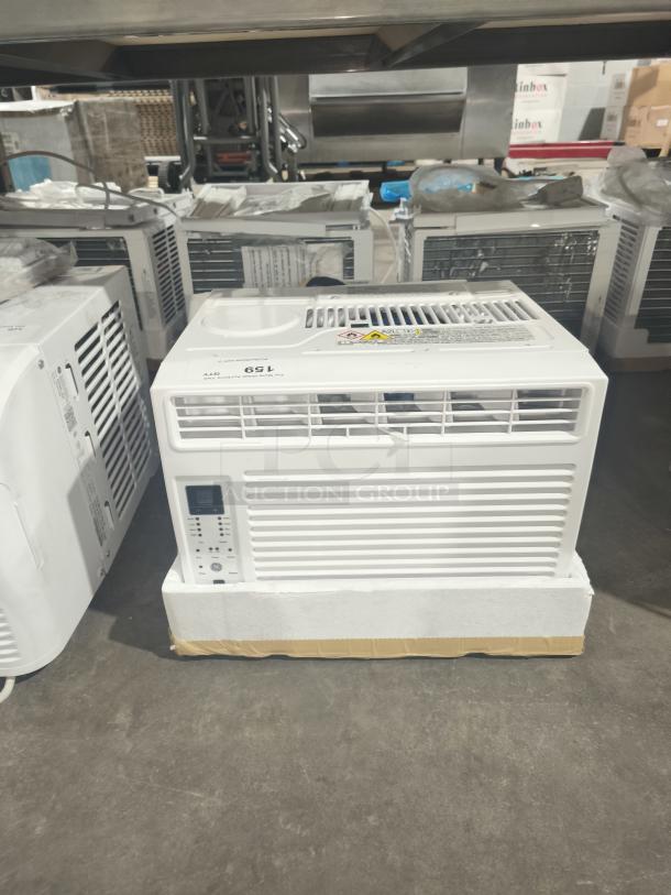 Brand new GE 6,000 BTU window air conditioner, model AWFS06BWL1, with electronic controls, in scratch and dent condition.