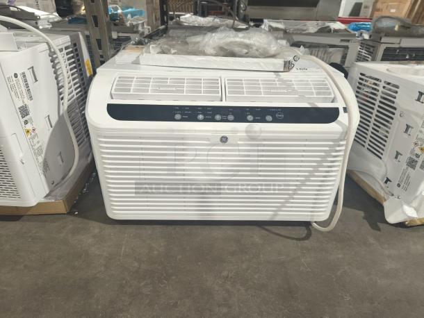 BRAND NEW SCRATCH AND DENT GE 6,200 BTU Ultra Quiet Window AC, Model AHD06LZQ1, for small rooms. White exterior, visible control panel.