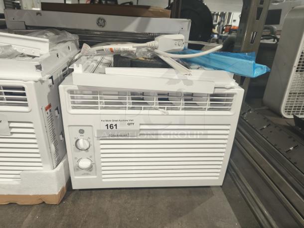 BRAND NEW GE 5000 BTU window AC, model AWFS05BWL, scratch and dent, for rooms up to 150 sq ft. Tags visible.