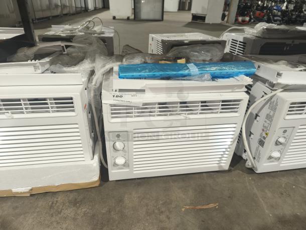 BRAND NEW GE 5000 BTU Window Air Conditioner, Model AWFS05BWL, for small rooms, visible stickers, minor scratches.