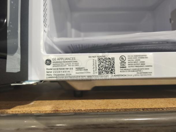 BRAND NEW GE 0.9 cu ft Microwave, Model GCST09N1WSS, scratch and dent, with manufacturer's label and warranty details.