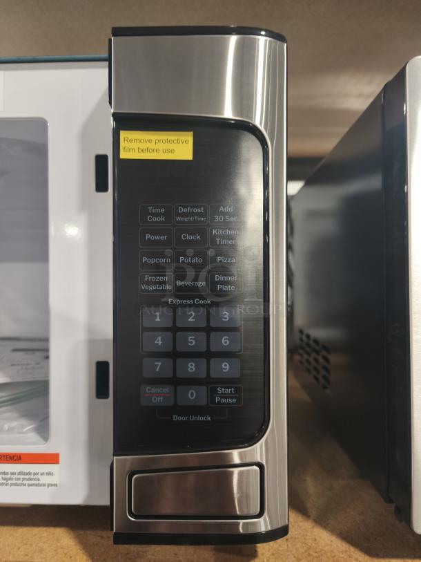 BRAND NEW GE 1.1 Cu. Ft. Countertop Microwave Oven, Model GCST11N1WSS. Scratch and dent item, protective film intact.