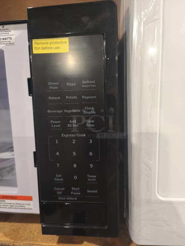 BRAND NEW GE 1.1 Cu. Ft. Countertop Microwave Oven, Model GCST11N1WSS, with control panel and protective film.