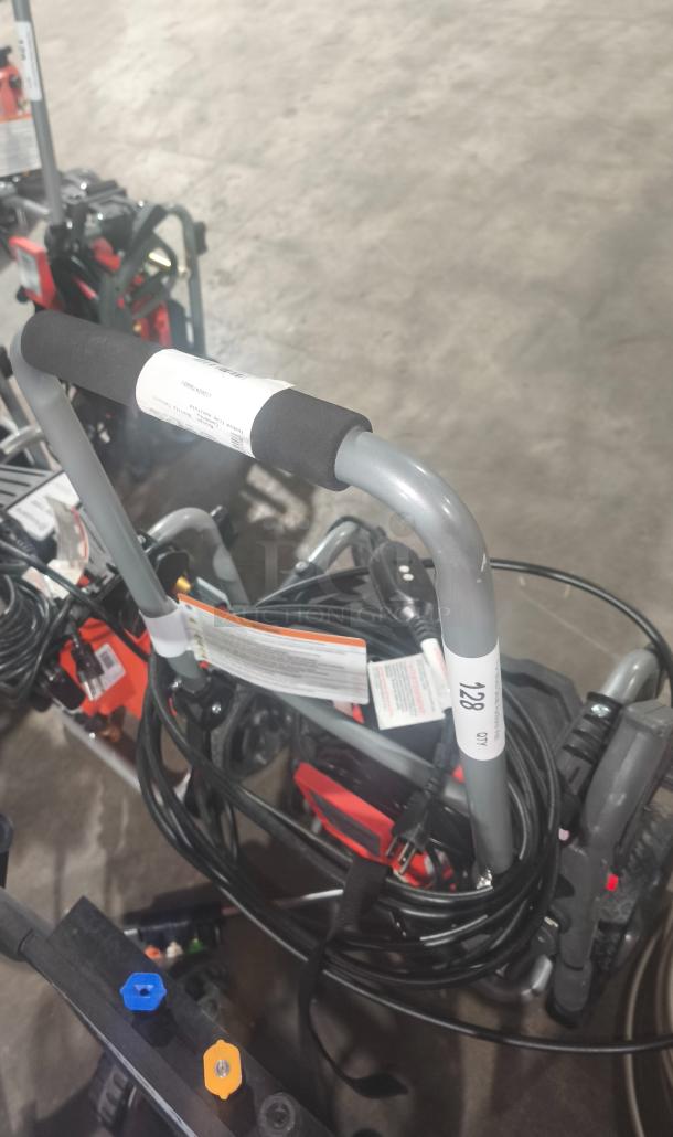 Husqvarna PW2300 Electric Pressure Washer in good condition. Includes hoses and nozzles, tested and working. Model number visible.