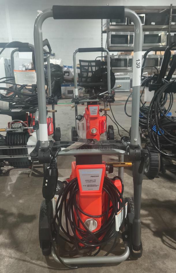 Husqvarna PW2300 electric pressure washer, tested and working. Features include 2300 max PSI, 1.2 max GPM, sturdy frame, and hose coil.