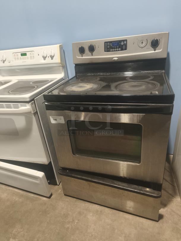 Whirlpool 30" freestanding electric range, model RF362LXSS. Features ceramic glass cooktop. Some surface wear visible.