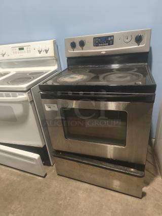 Whirlpool 30" freestanding electric range, model RF362LXSS. Features ceramic glass cooktop. Some surface wear visible.