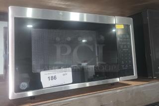 BRAND NEW SCRATCH AND DENT GE 0.9 cu ft countertop microwave, model GCST09N1WSS, stainless finish, visible keypad.