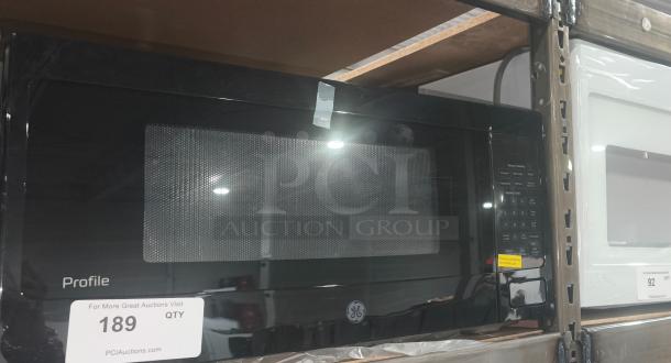 BRAND NEW GE 1.1 Cu. Ft. Countertop Microwave, Model GCST11N1WSS. Black finish, minor scratches, dented; includes control panel and GE logo.