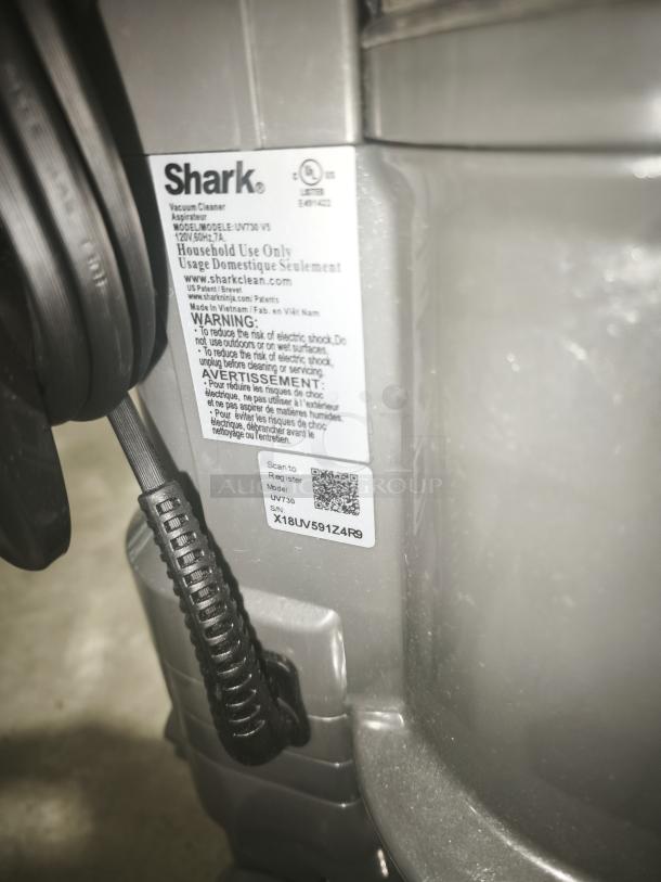 Shark UV730 Navigator Lift‑Away vacuum with visible label, tested and working, gray, household use, serial X18UV591ZAF9.