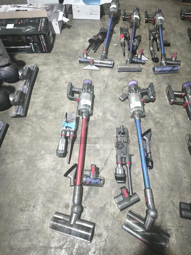 Dyson V11 Torque Drive PLUS cordless stick vacuums on display; tested, working condition, various accessories visible.