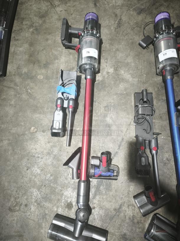 Dyson V11 Torque Drive PLUS cordless stick vacuum, tested and working, shown with attachments and accessories.