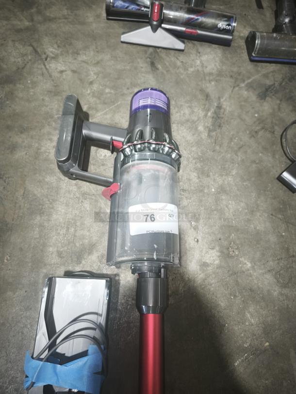 Dyson V11 Torque Drive PLUS cordless stick vacuum, tested and working, with red wand and visible auction label.