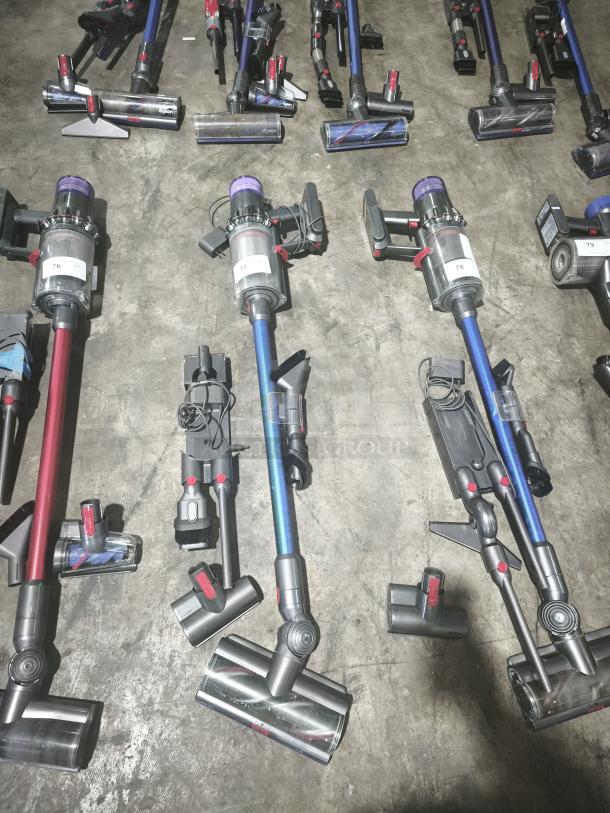 Dyson V11 Torque Drive PLUS cordless stick vacuums, tested and working, in good condition, visible model labels.
