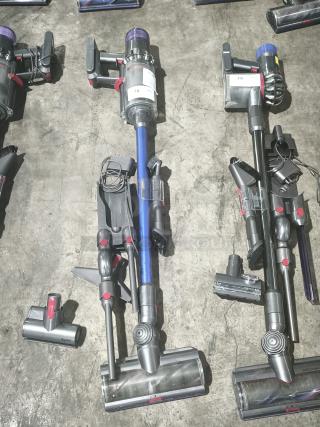 Dyson V11 Torque Drive PLUS cordless stick vacuum, tested and working, shown with attachments, blue and gray finish.