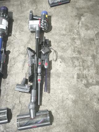 Dyson V11 Torque Drive PLUS cordless stick vacuum, tested and working, with attachments, visible anti-tangle comb, in used condition.