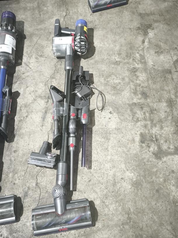 Dyson V11 Torque Drive PLUS cordless stick vacuum, tested, with attachments, in good condition, visible anti-tangle comb label.