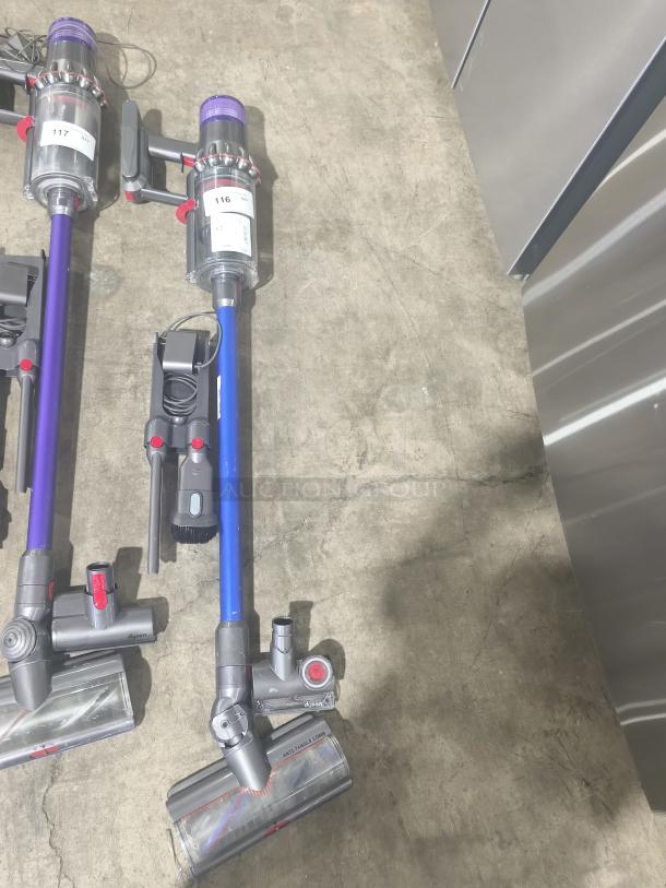 Dyson V11 Torque Drive PLUS cordless vacuum on concrete floor, tested and working, with blue stick and attachments visible.