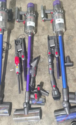 Dyson V11 Torque Drive PLUS cordless vacuum, tested and working, with purple and gray body, attachments, and tags visible.