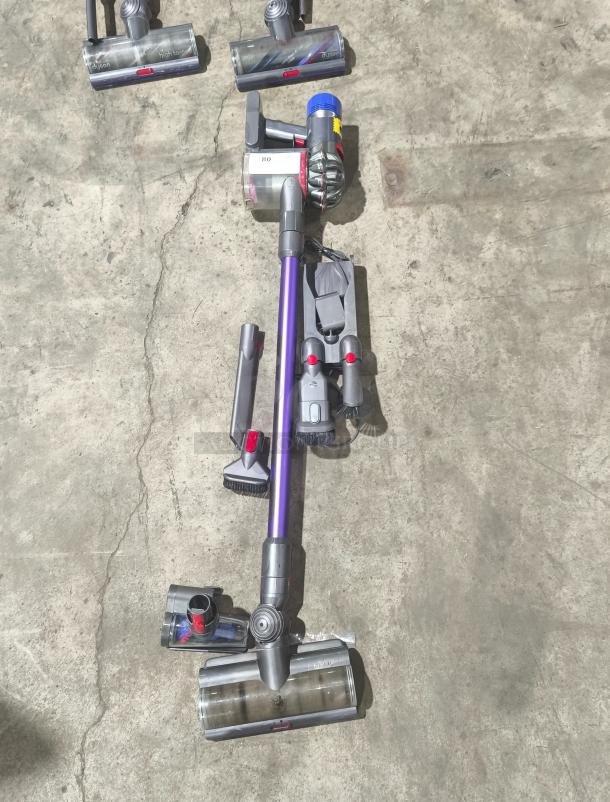 Dyson V11 Torque Drive PLUS cordless stick vacuum, tested and working, includes attachments, in good condition.