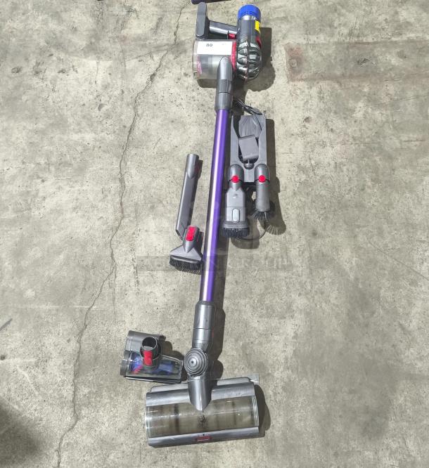 Dyson V11 Torque Drive PLUS cordless stick vacuum, tested and working, with accessories shown.