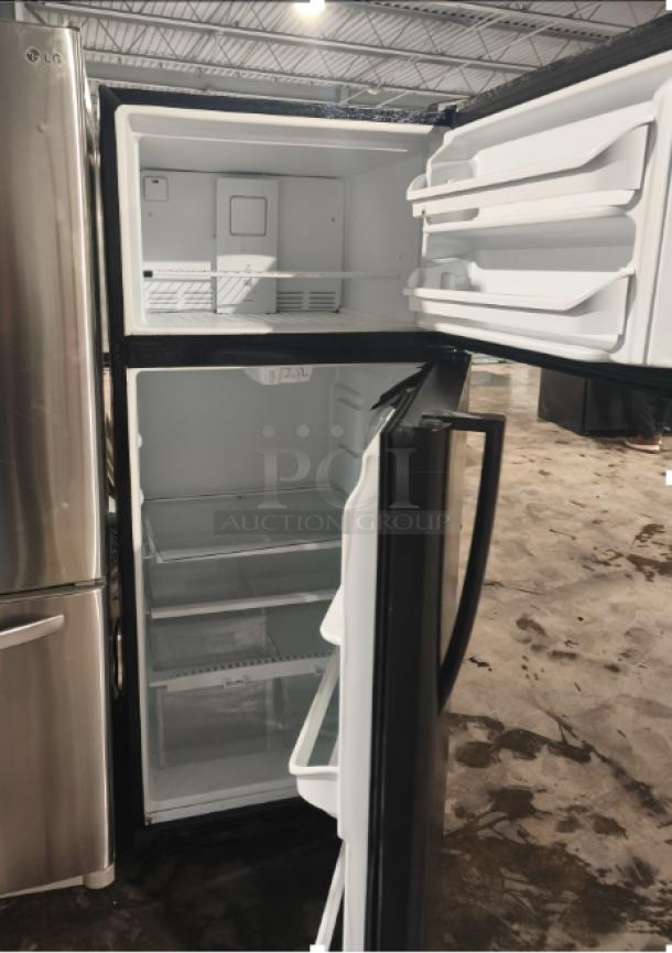 Frigidaire FFTR1821TB 18 Cu. ft. black top freezer refrigerator, open doors, spacious interior, model FFTR1821TB0.