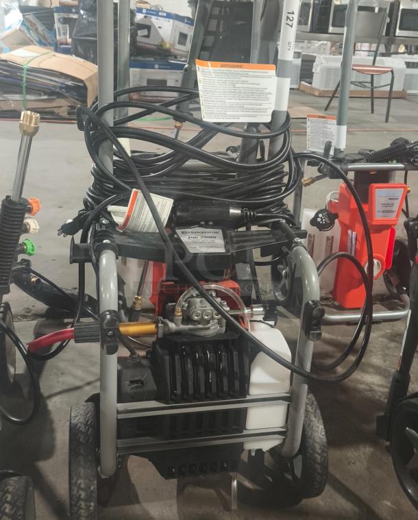 Husqvarna PW2300 Electric Pressure Washer, tested working, with visible labels and coiled hose. Model PW2300.