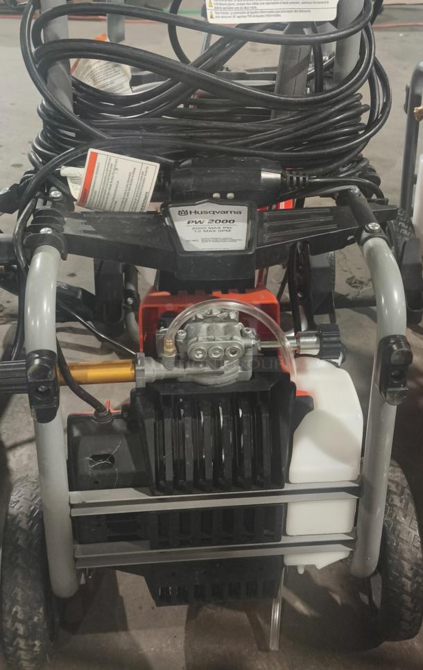 Husqvarna PW2300 electric pressure washer, tested and working. Visible labels showing operating instructions and model information.