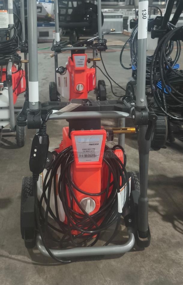 Husqvarna PW2300 Electric Pressure Washer, tested, working condition. Features 2300 PSI, sturdy frame, visible hose coiled neatly.