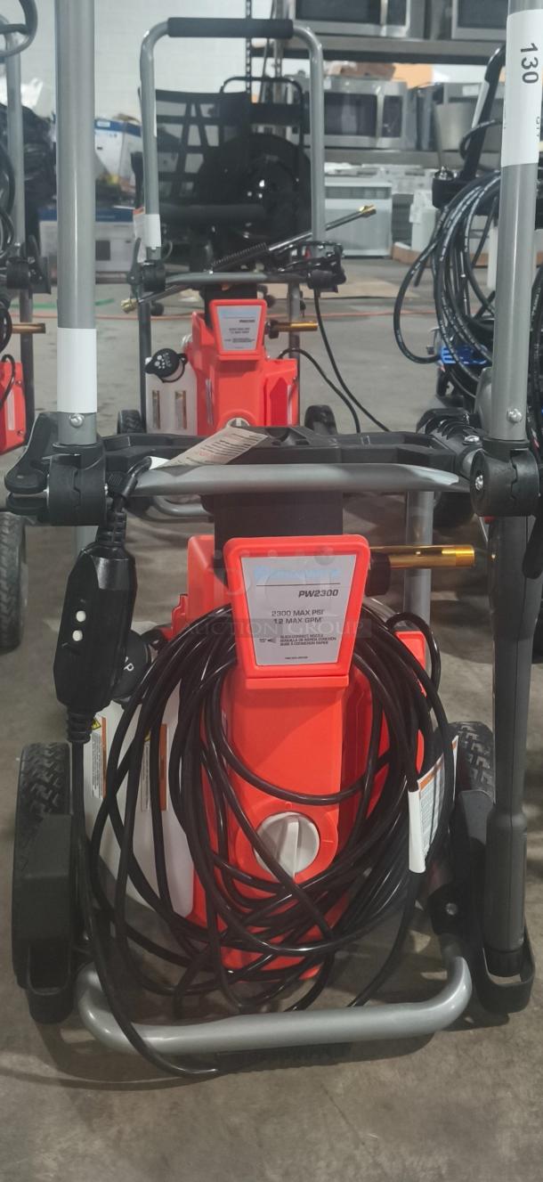 Husqvarna PW2300 Electric Pressure Washer, 2300 PSI, tested and working, features coiled hose, sturdy handle, and wheels.