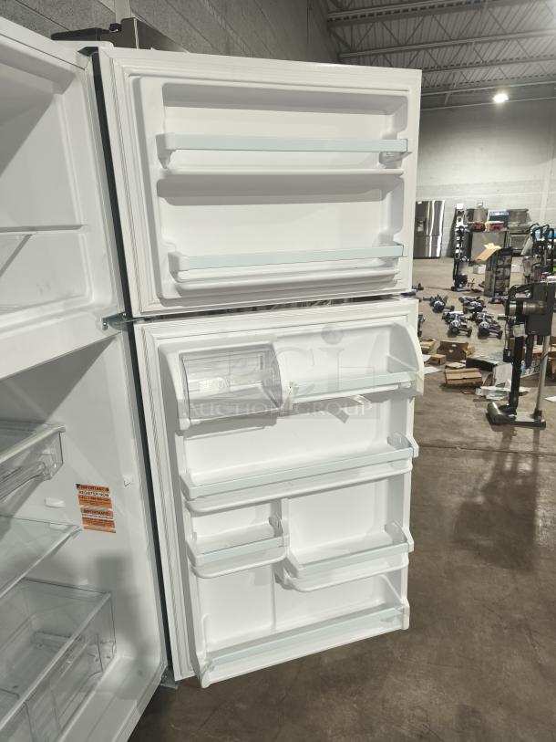 Whirlpool 30-inch top-freezer refrigerator, model WRT318FZDW, 18 cu ft, open doors showing shelves and bins, tested and working.